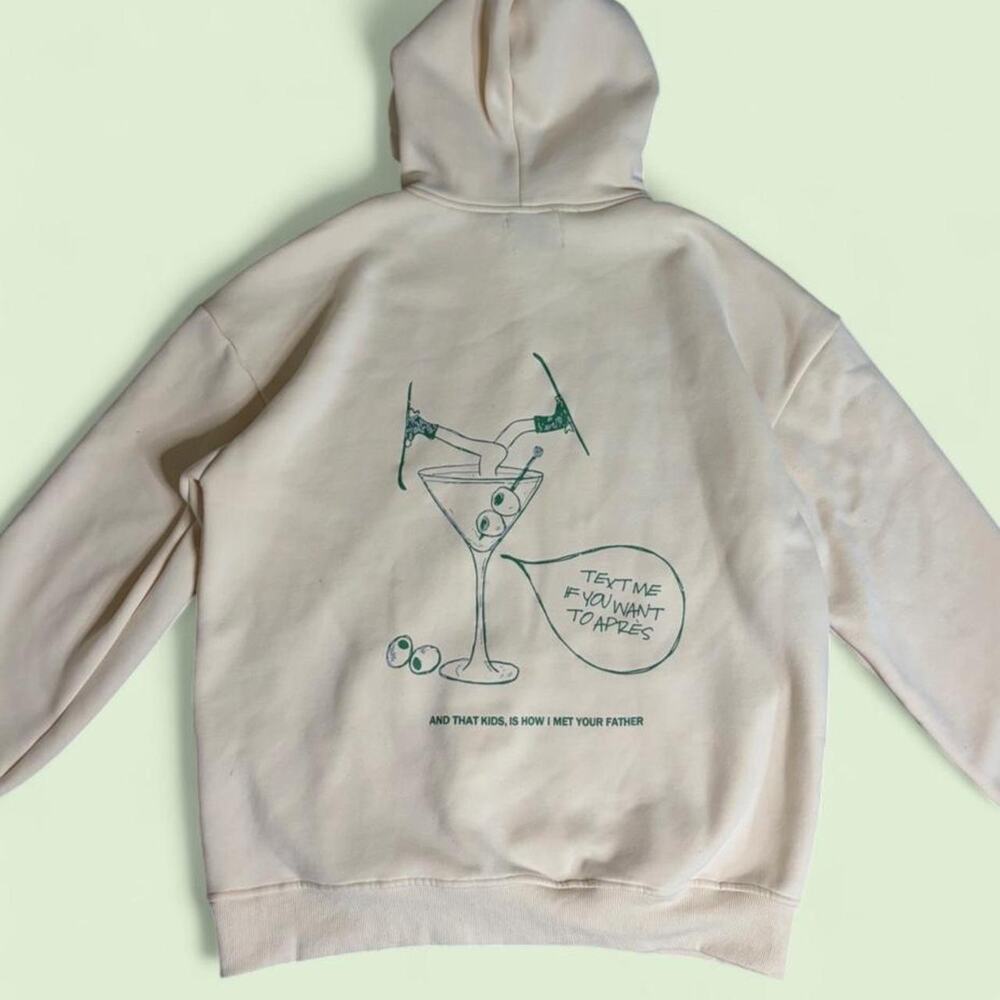 Rebellious Ski Club cream hoodie with green graphic of a martini glass - size M